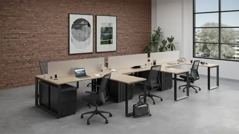 Open office with L-shaped desks, privacy screens, task chairs and mobile file cabinets